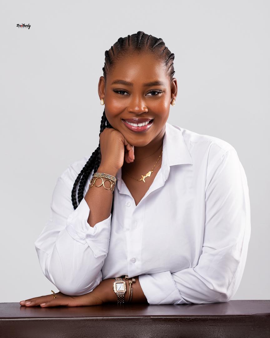 Smiling woman in a white shirt with long braids