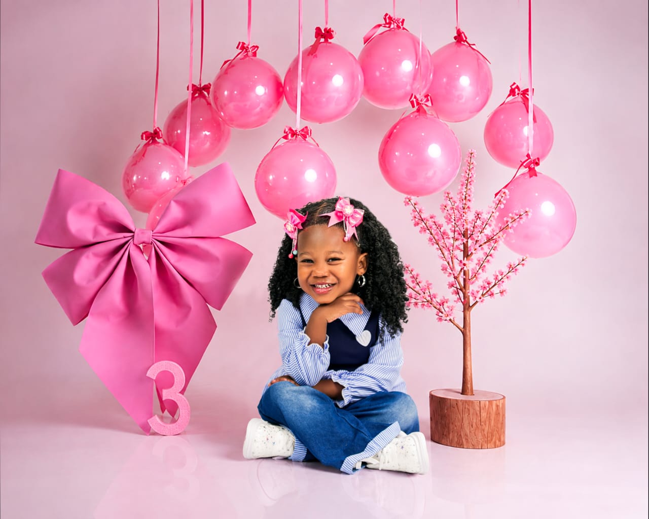 Third birthday portrait in pink with balloons