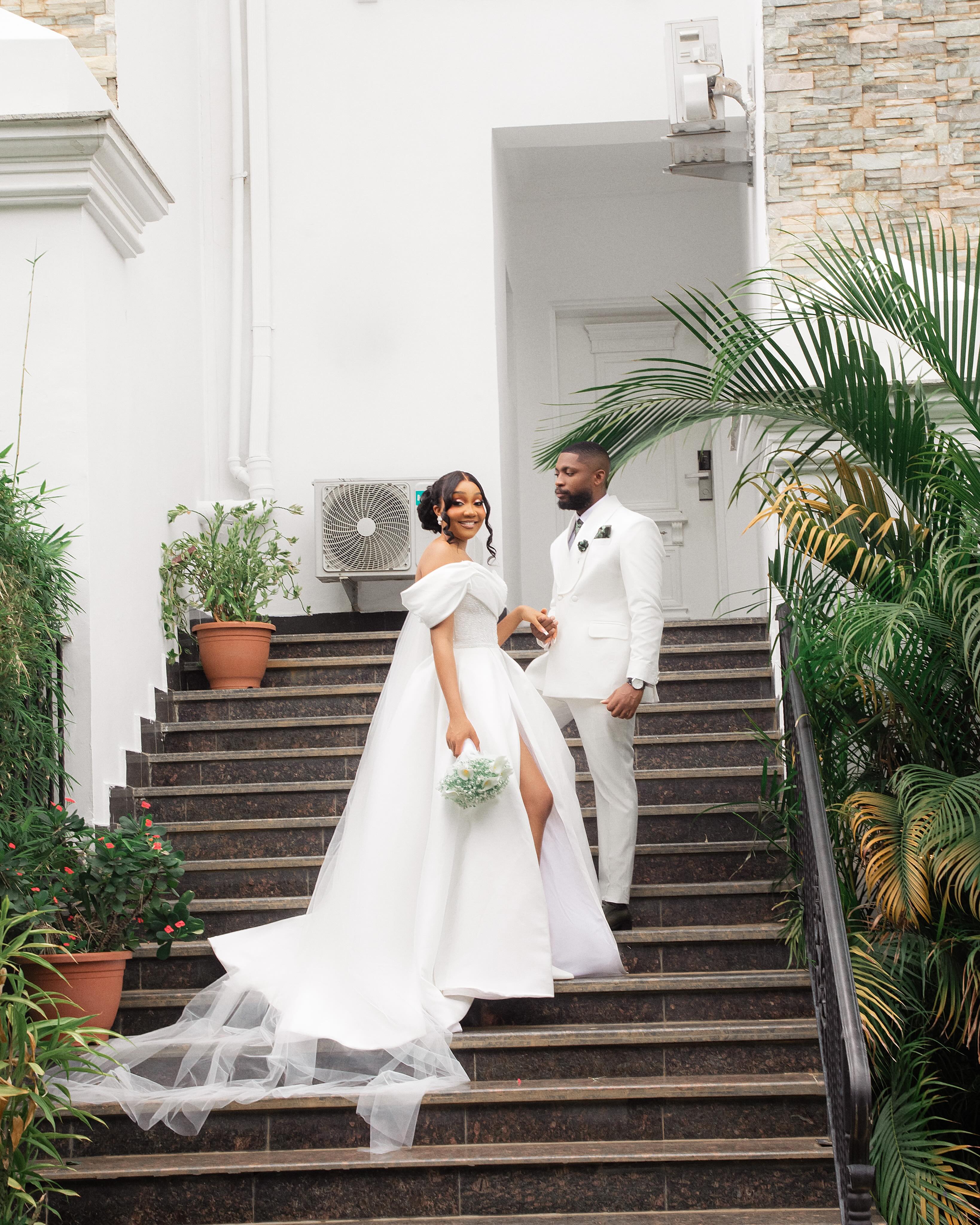Bride and groom posed on grand outdoor stairs