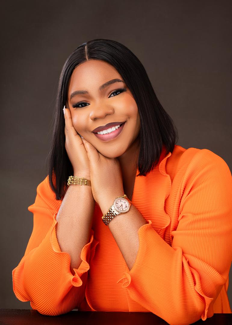 Smiling woman in an orange pleated top