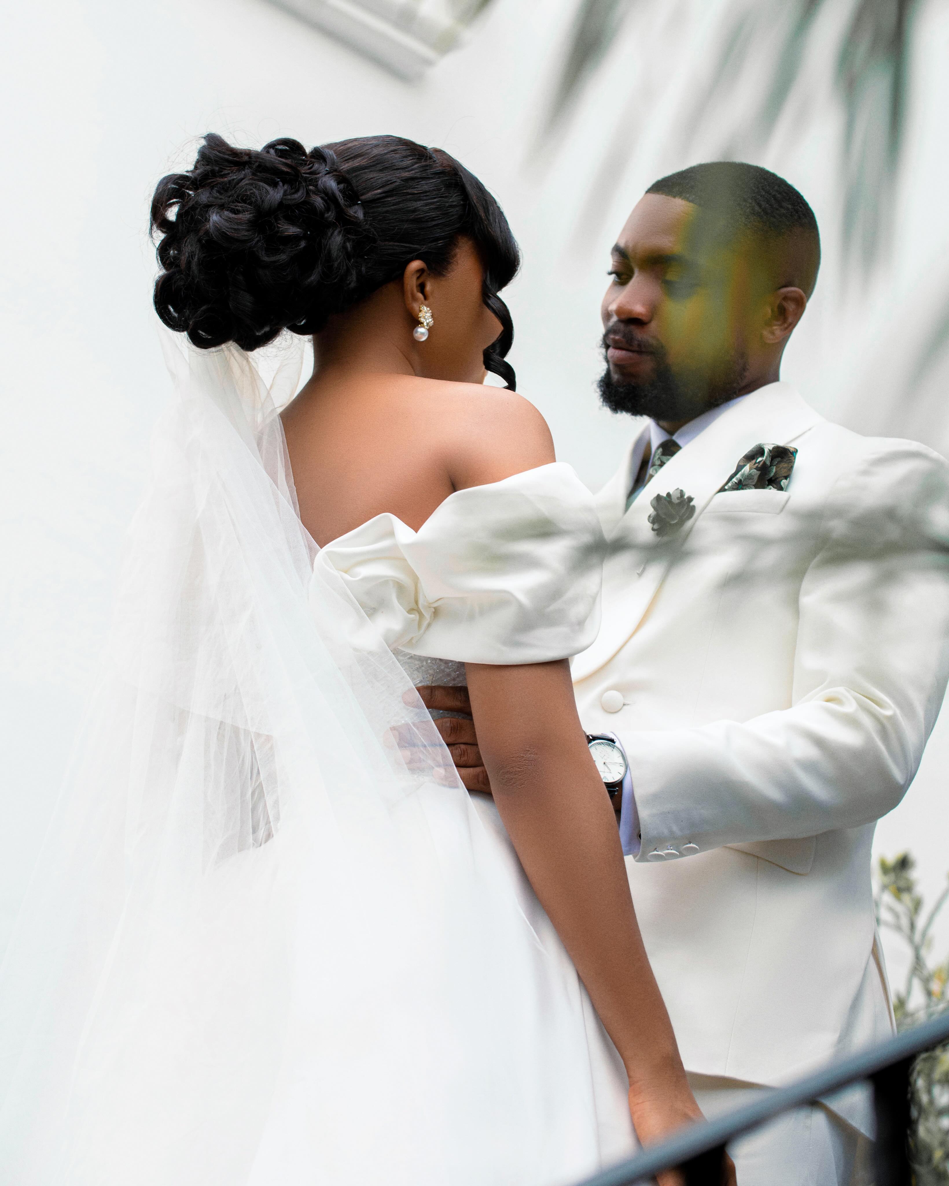 Bride and groom sharing a quiet moment among foliage
