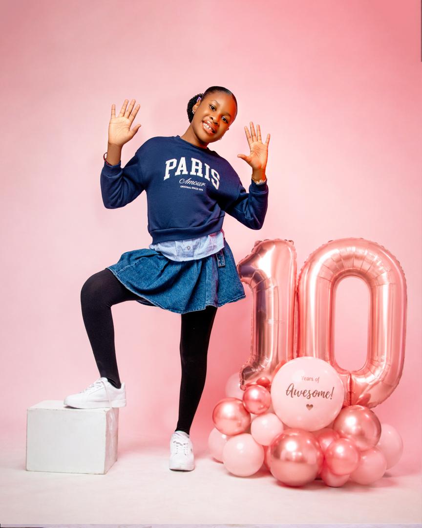 Tenth birthday portrait with rose-gold balloons