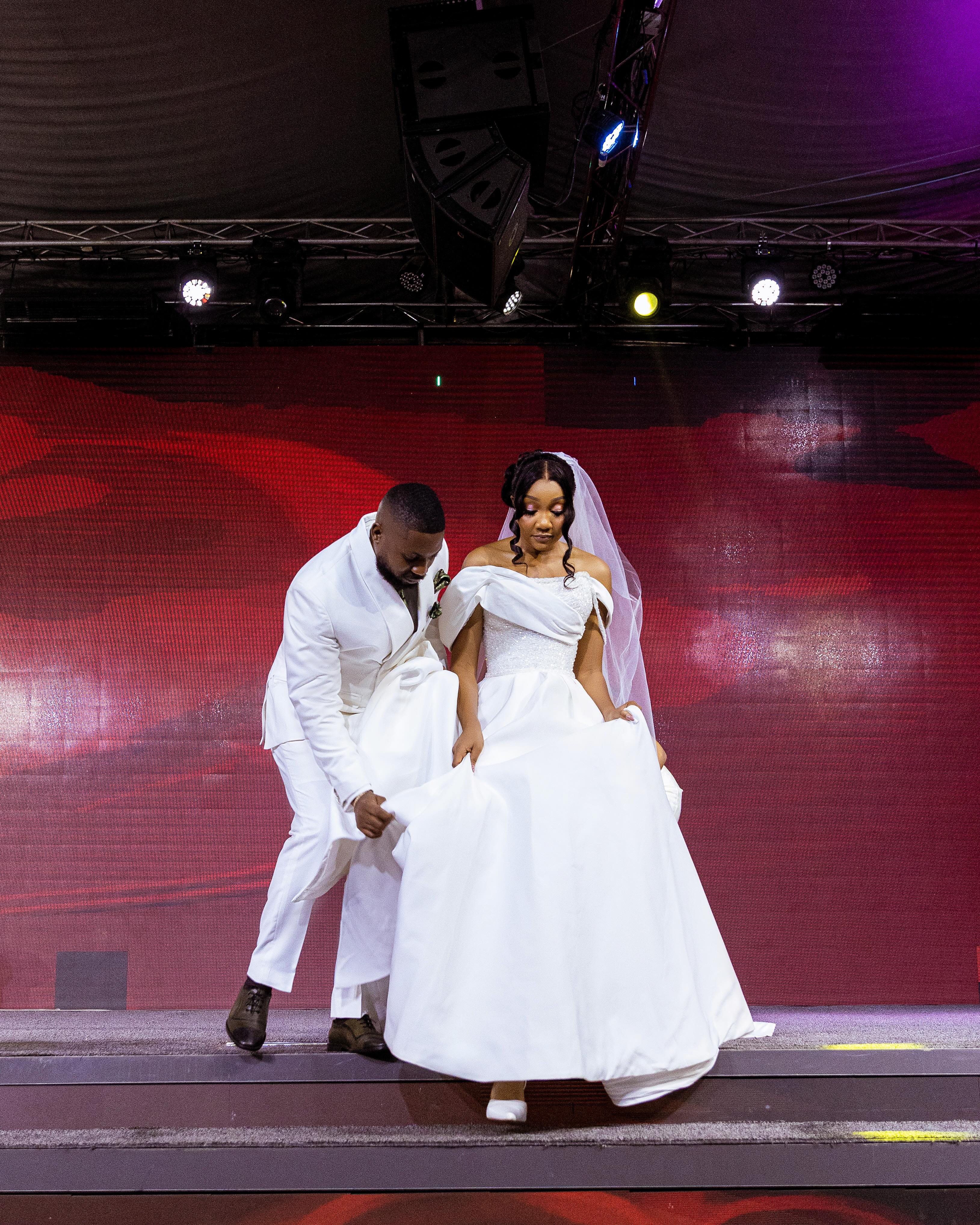 Newlyweds dancing on an LED-lit stage