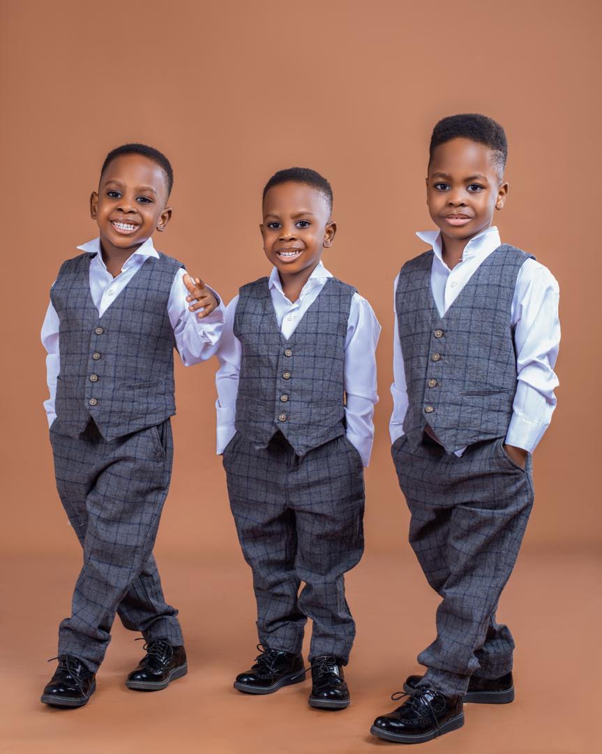 Triplets in grey tweed vests