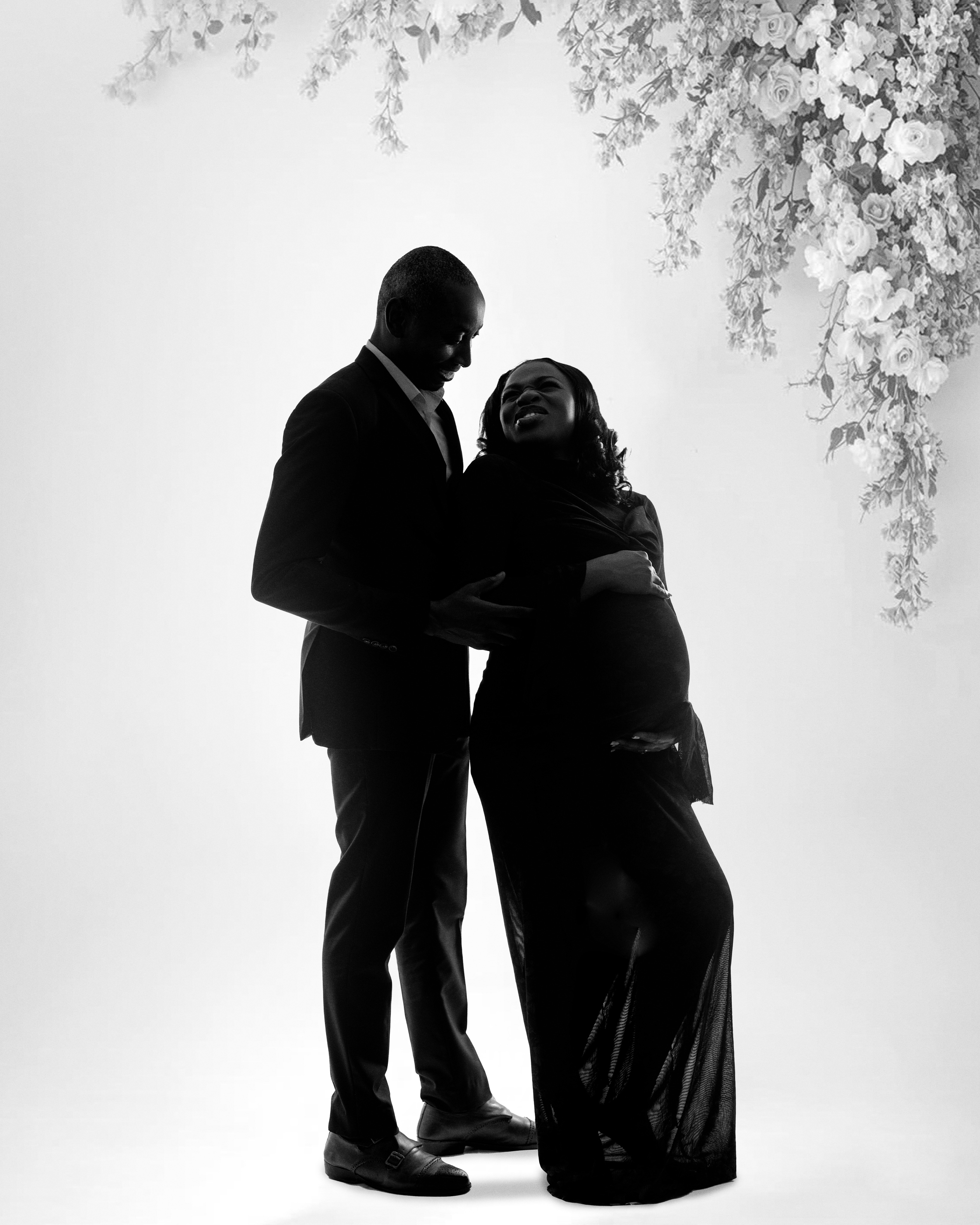 Black-and-white maternity portrait of an expectant couple