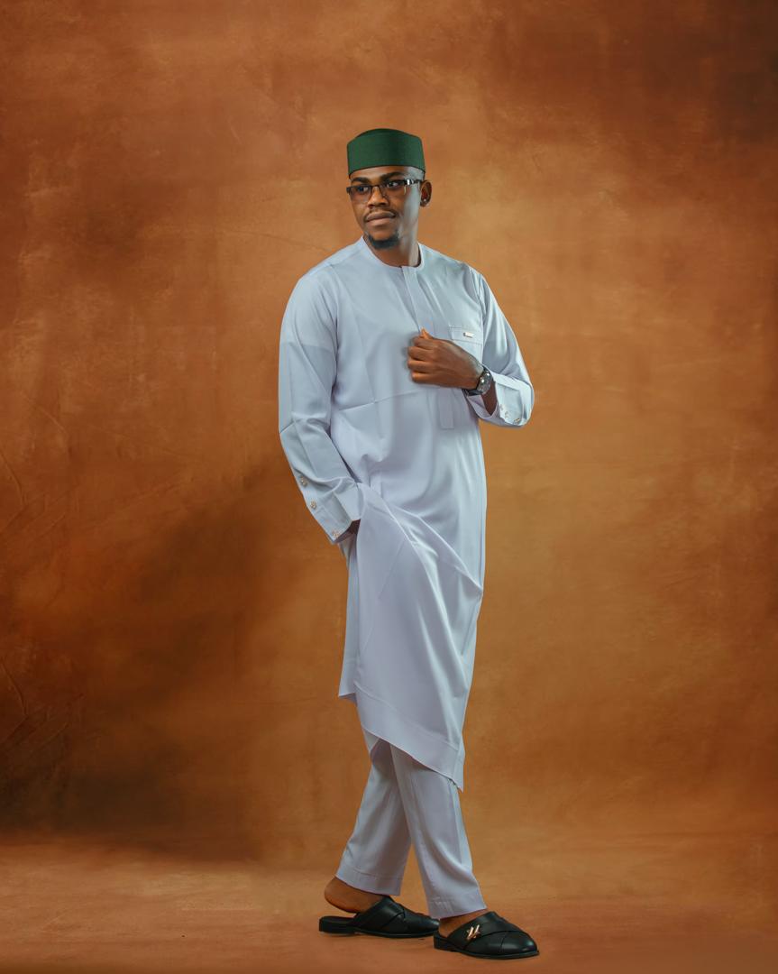 Man in a white kaftan and green cap